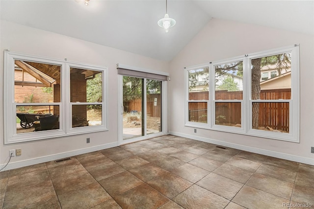 unfurnished sunroom featuring a wealth of natural light and lofted ceiling