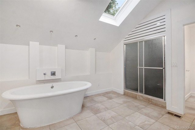 bathroom featuring vaulted ceiling with skylight and separate shower and tub