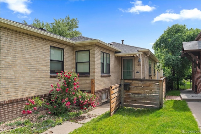 1540 Filbert Ct, Denver, CO 80220 - view of front of property featuring brick siding, roof with shingles, and a front yard