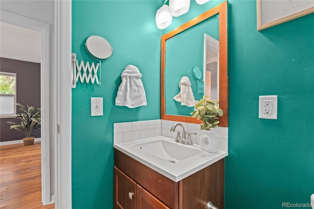 1540 Filbert Ct, Denver, CO 80220 - bathroom with vanity, wood finished floors, and baseboards