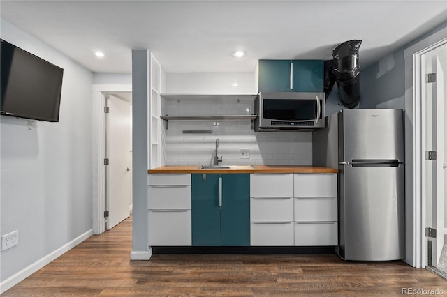 1540 Filbert Ct, Denver, CO 80220 - kitchen featuring wood counters, appliances with stainless steel finishes, a sink, decorative backsplash, and recessed lighting