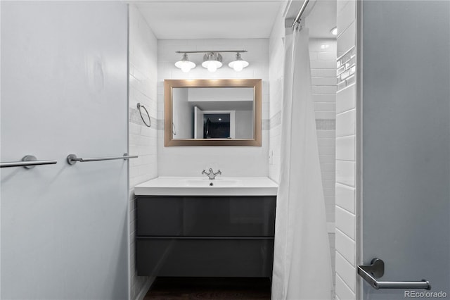 1540 Filbert Ct, Denver, CO 80220 - full bathroom featuring vanity, curtained shower, and tile walls