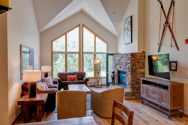 23110 US Highway 6 Unit 5040, Keystone, CO 80435 - living area with a stone fireplace, light wood-type flooring, and high vaulted ceiling