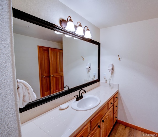 23110 US Highway 6 Unit 5040, Keystone, CO 80435 - bathroom featuring wood finished floors and vanity