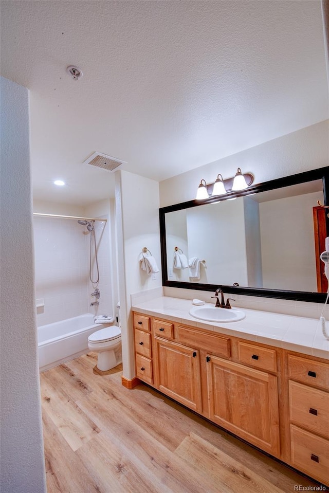 23110 US Highway 6 Unit 5040, Keystone, CO 80435 - full bath with wood finished floors, vanity, bathing tub / shower combination, and a textured ceiling