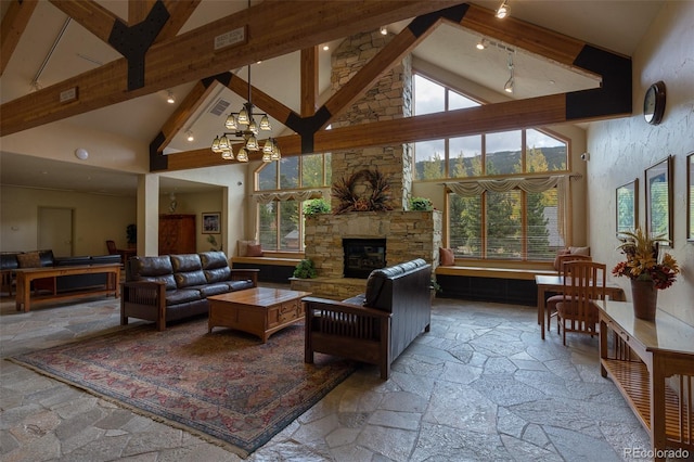 23110 US Highway 6 Unit 5040, Keystone, CO 80435 - living room with high vaulted ceiling, stone tile floors, a fireplace, beam ceiling, and a chandelier