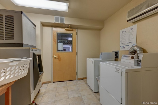 23110 US Highway 6 Unit 5040, Keystone, CO 80435 - shared laundry featuring an AC wall unit, independent washer and dryer, and light tile patterned floors