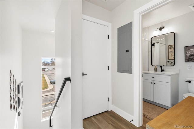 5363 W 14th Ave, Lakewood, CO 80214 - hallway featuring electric panel, wood finished floors, baseboards, and a sink
