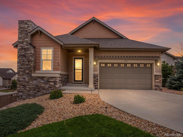 view of front of property with stone siding, a garage, a chimney, concrete driveway, and roof with shingles