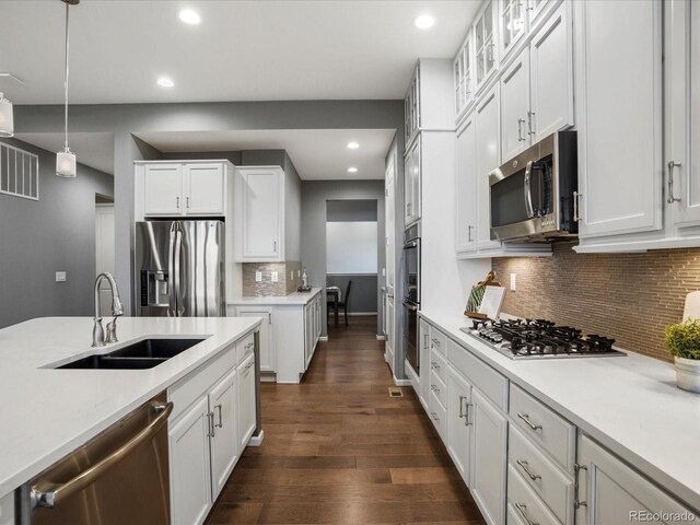 kitchen with a sink, recessed lighting, white cabinetry, and appliances with stainless steel finishes