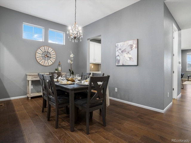 dining room featuring an inviting chandelier, baseboards, and dark wood finished floors