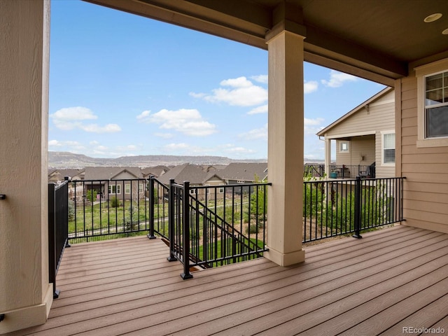 wooden deck featuring a residential view and a mountain view