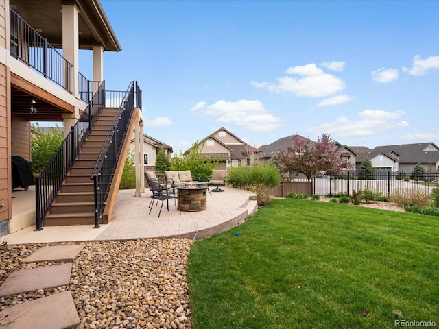 view of yard featuring a fire pit, a patio, stairway, and fence