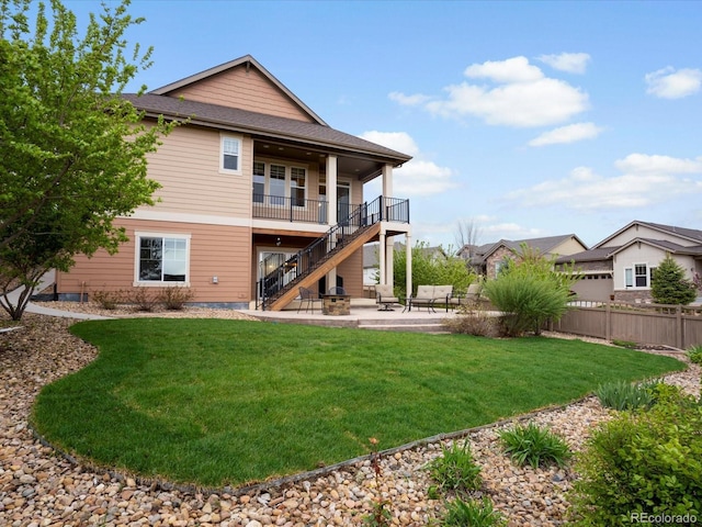 back of house with fence, stairs, a patio area, and a lawn