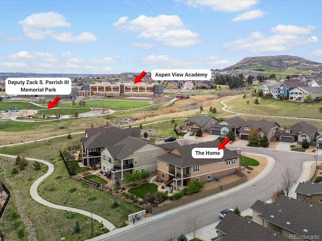 birds eye view of property with a mountain view and a residential view