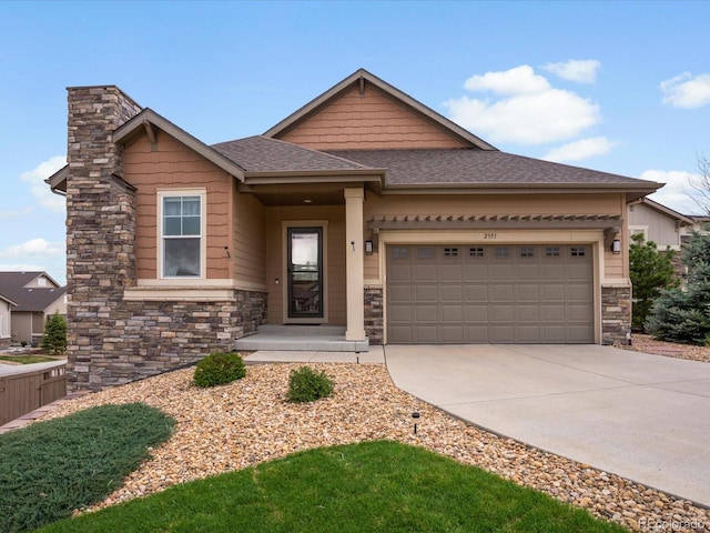 craftsman-style home with stone siding, roof with shingles, driveway, and a garage