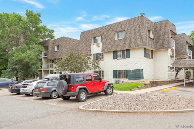 5770 E Warren Ave Unit 206, Denver, CO 80222 - view of building exterior featuring uncovered parking