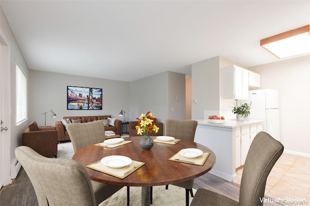 5770 E Warren Ave Unit 206, Denver, CO 80222 - dining space with light wood-style floors