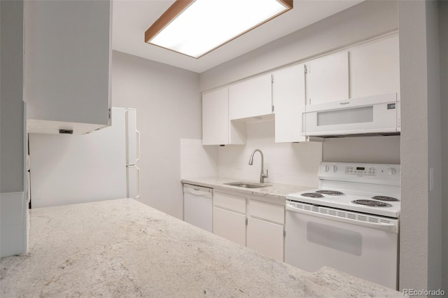 5770 E Warren Ave Unit 206, Denver, CO 80222 - kitchen featuring white appliances, tasteful backsplash, white cabinets, and light stone countertops