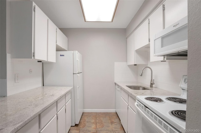5770 E Warren Ave Unit 206, Denver, CO 80222 - kitchen with white appliances, backsplash, white cabinetry, and light stone counters