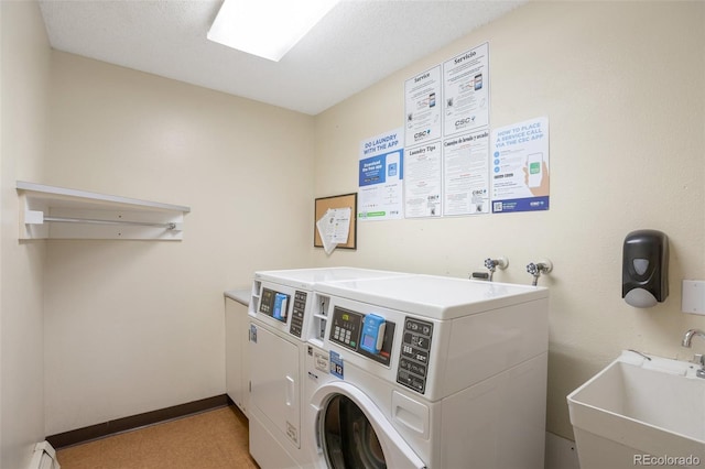 5770 E Warren Ave Unit 206, Denver, CO 80222 - shared laundry room featuring separate washer and dryer and baseboard heating