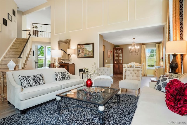 2061 Chesapeake Pl, Highlands Ranch, CO 80126 - living area featuring wood finished floors, a towering ceiling, a chandelier, and stairs