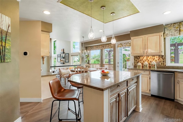 2061 Chesapeake Pl, Highlands Ranch, CO 80126 - kitchen with dishwasher, light brown cabinetry, dark wood-type flooring, a breakfast bar, and a center island