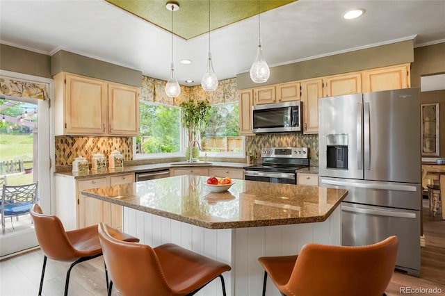 2061 Chesapeake Pl, Highlands Ranch, CO 80126 - kitchen with appliances with stainless steel finishes, light brown cabinets, healthy amount of natural light, decorative backsplash, and ornamental molding