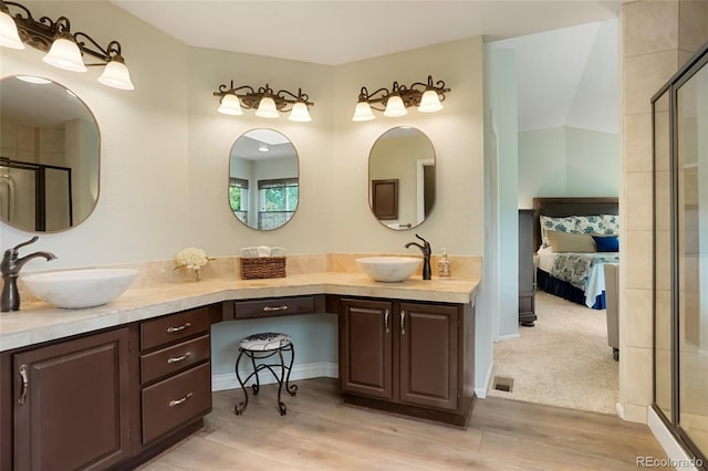 2061 Chesapeake Pl, Highlands Ranch, CO 80126 - ensuite bathroom featuring double vanity, wood finished floors, and a shower with door