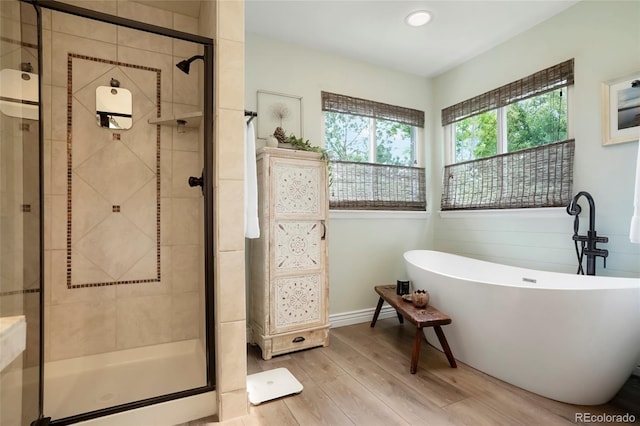 2061 Chesapeake Pl, Highlands Ranch, CO 80126 - full bathroom featuring a freestanding bath, wood finished floors, a shower stall, and recessed lighting
