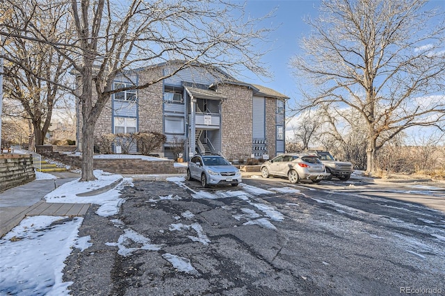 view of front of property featuring uncovered parking and brick siding