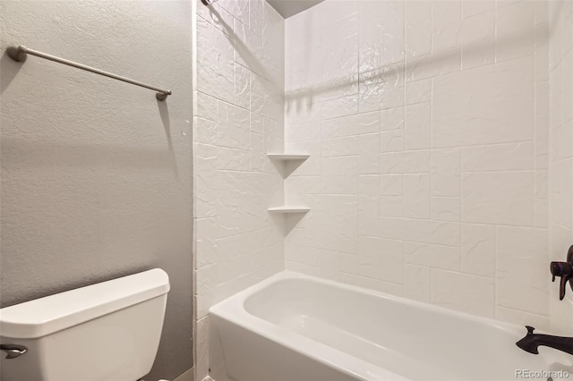 full bathroom with a textured wall, toilet, and shower / bathtub combination