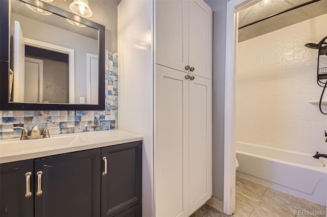 full bathroom with toilet, bathing tub / shower combination, backsplash, and vanity