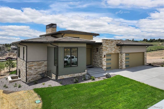 prairie-style house featuring a front yard and a garage