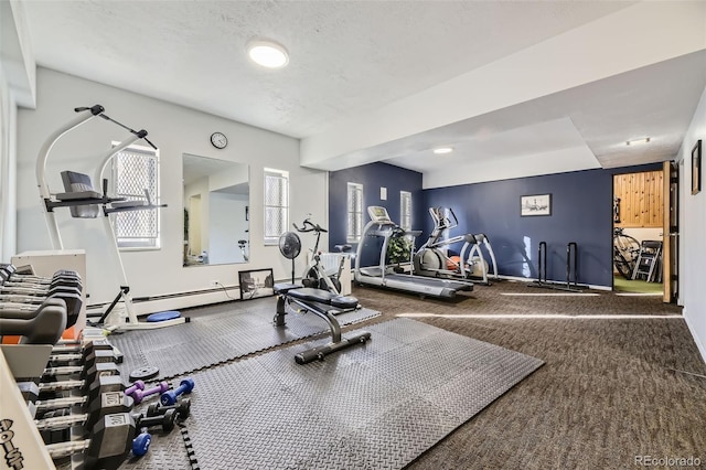 workout area featuring carpet flooring, a textured ceiling, and baseboard heating