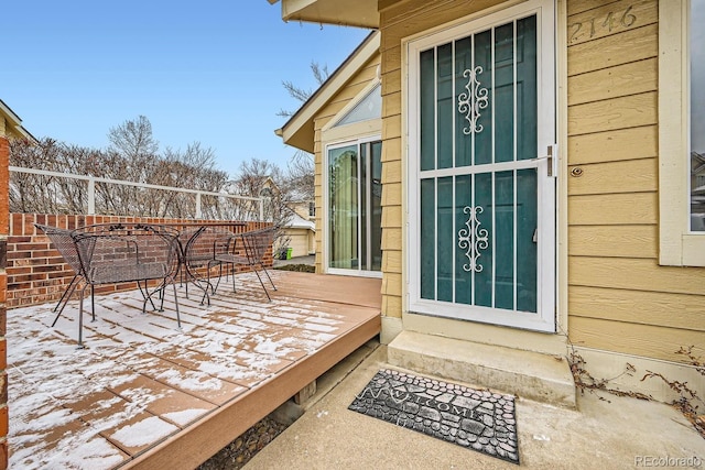 view of exterior entry featuring a deck