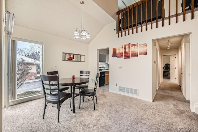 dining room with high vaulted ceiling, a notable chandelier, visible vents, baseboards, and carpet