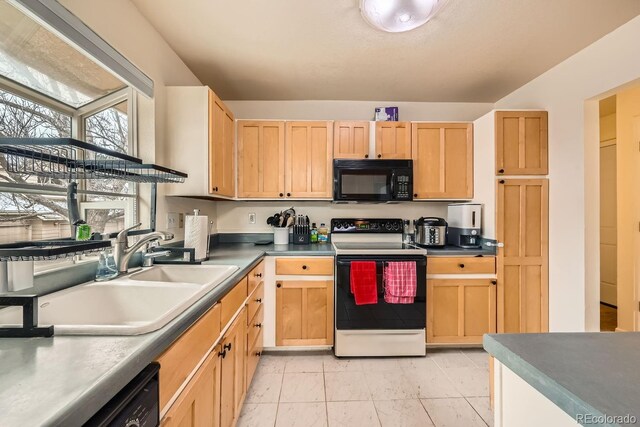 kitchen featuring electric range oven, light brown cabinetry, a sink, and black microwave