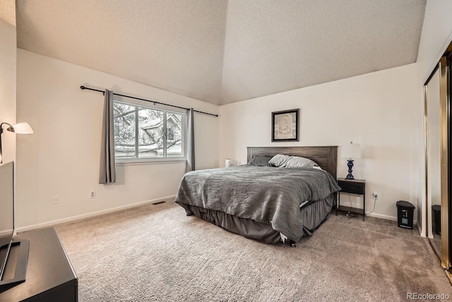 bedroom with carpet, visible vents, lofted ceiling, and a textured ceiling