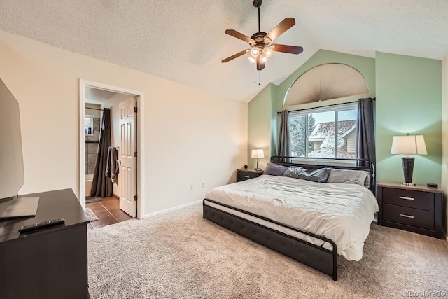 bedroom featuring carpet, baseboards, vaulted ceiling, and a textured ceiling