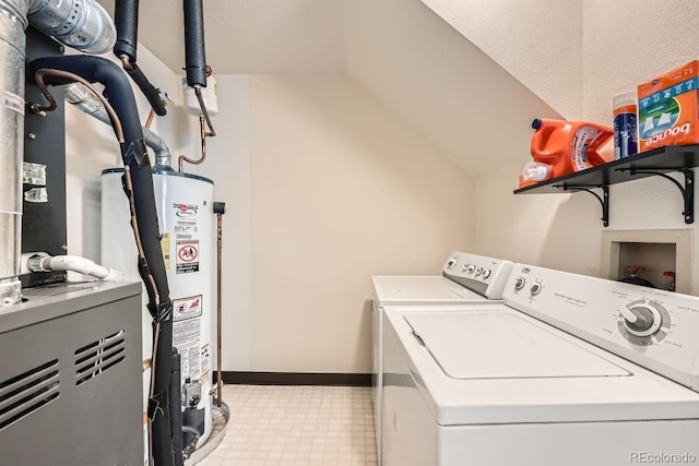 laundry room with light floors, water heater, washer and dryer, laundry area, and baseboards