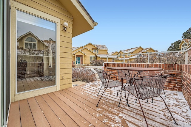 wooden deck with outdoor dining area and a residential view