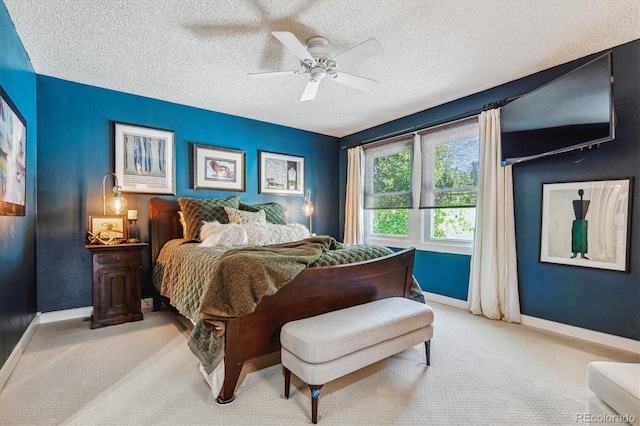 carpeted bedroom with ceiling fan and a textured ceiling