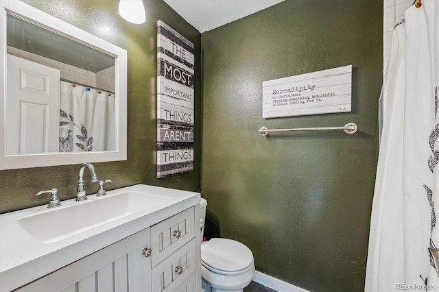 bathroom featuring toilet and vanity