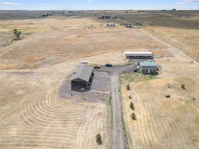 birds eye view of property with a rural view