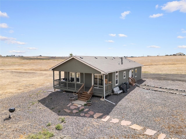 view of front of property featuring a rural view and covered porch