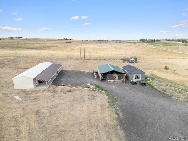 birds eye view of property with a rural view