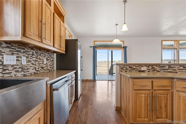 kitchen featuring decorative backsplash, decorative light fixtures, dishwasher, and dark hardwood / wood-style flooring