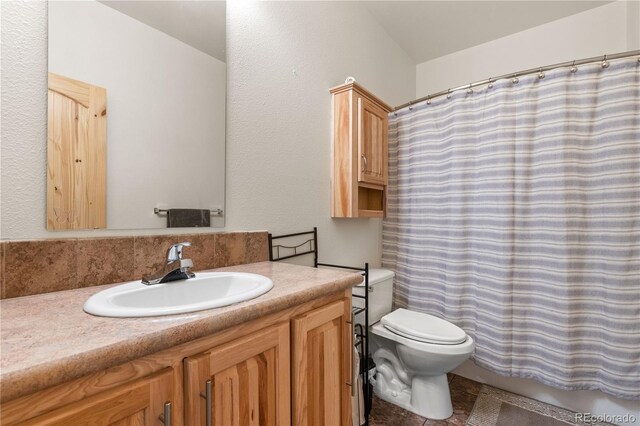 bathroom with vanity, toilet, and a shower with shower curtain