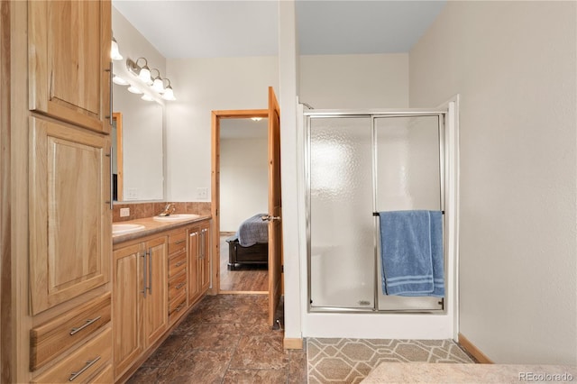 bathroom featuring vanity and a shower with shower door